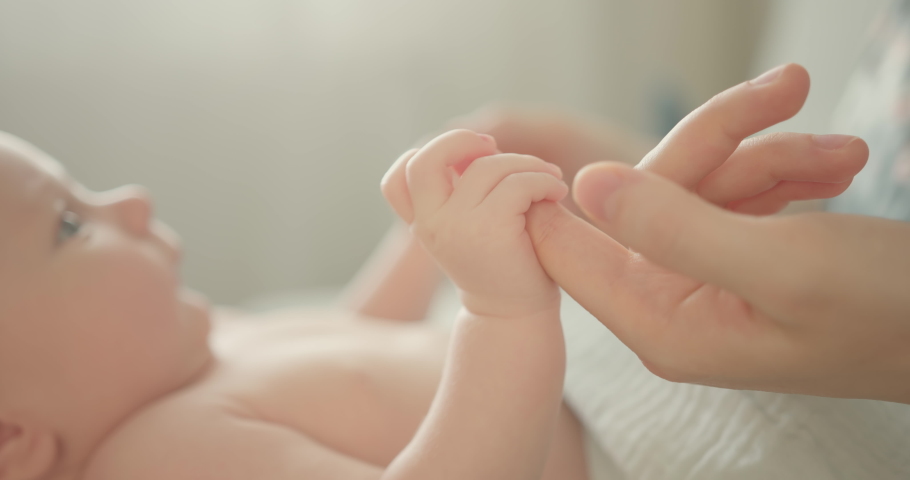 Holding newborns hand in Slow Motion . Happy Family Mother and her Newborn Baby together. Maternity concept. Parenthood. Motherhood. | Shutterstock HD Video #1071847258