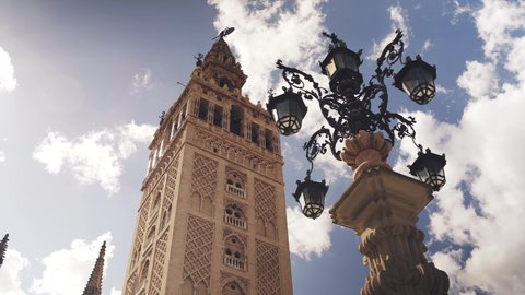 Vision of the Giralda of Seville behind the fountain of the lamppost in the Virgin of the Kings square (Plaza Virgen de los Reyes) of Seville
