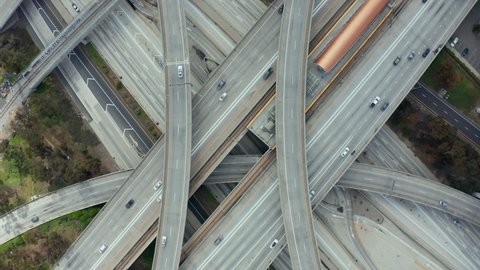 AERIAL: Spectacular Overhead Shot of Judge Pregerson Interchange showing multiple Roads, Bridges, Highway with little car traffic in Los Angeles, California on Beautiful Sunny Day