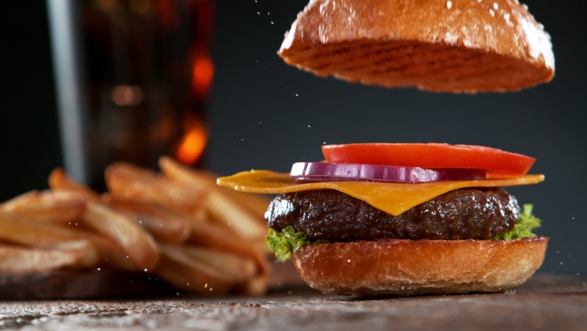 Beef Burger Ingredients Falling and Landing in the Bun Royalty-Free Stock Footage #1071881974