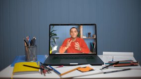Video communication online via a laptop. Young man teaches online