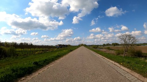 Dutch polder dike road nice clouds spring day POV