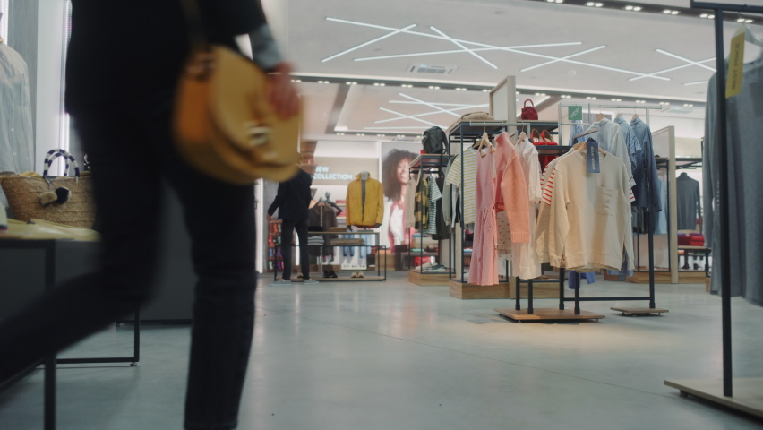Clothing Store: Diverse Group of Costumers Shopping, buying Clothes and Merchandise at Checkout Cashier Counter. Retail Shopping Mall Assistant Helps Clients, Selling Brands. Wide Establishing Shot | Shutterstock HD Video #1071893962