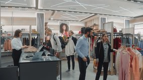 Clothing Store: Diverse Group of Costumers Shopping, buying Clothes and Merchandise at Checkout Cashier Counter. Retail Shopping Mall Assistant Helps Clients, Selling Brands. Wide Establishing Shot - Powered by Shutterstock - Get 15% off with code: PIKWIZARD15