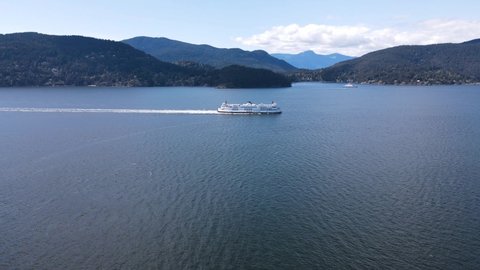 West Vancouver, BC, Canada- May 5, 2021: Aerial view of big Ferry traveling to Horseshoe Bay with Bowen island in the background. 4K 60FPS
