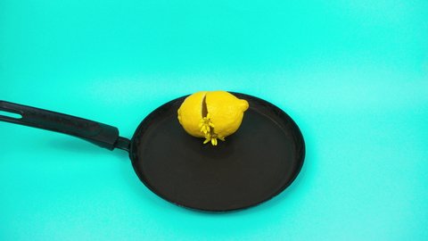 4k Food and metamorphosis creativity concept. Lemon breaks over frying pan and yellow, white flowers flow out of it, fried in frying pan they turn into scrambled eggs on plate. Stop motion animation.