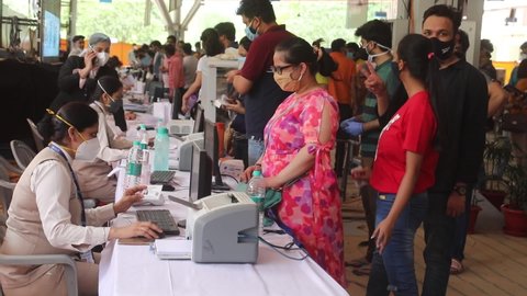 New Delhi, India, May 5, 2021: People wearing face mask register them-selves for the dose of the coronavirus (COVID-19) vaccine, manufactured by Serum Institute of India, at covid-19 vaccination    