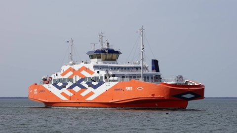 Virtsu, Estonia- 17.04.2021: passanger ferry Connecting Estonia mainland and Muhu island. Orange Piret Ferry arriving from Saaremaa to Kuivastu. ferry crossing, 4K UHD