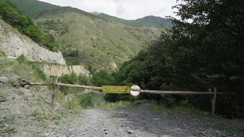 Wooden barrier with a sign prohibiting entry to the land. Border Georgia-Chechnya. Caucasus