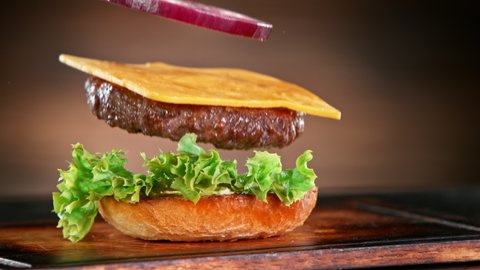 Super Slow Motion Shot of Falling and Stacking Parts of Hamburger at 1000fps. Adlı Stok Video