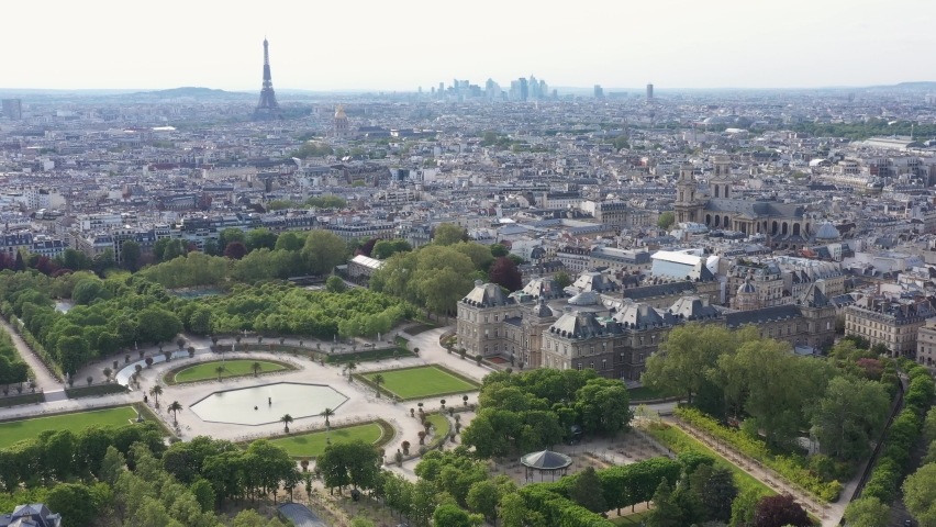 France, Paris, Luxembourg Gardens and Palais (French Senate) with Eiffel Tower and La Defense in back, LONG drone aerial view Royalty-Free Stock Footage #1071921859