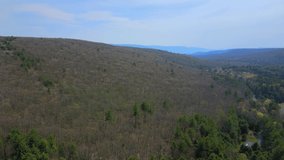 Aerial drone video footage of the appalachian mountains on a sunny spring day. This is in the catskill mountains, which is a subrange of the appalachians in new york's hudson valley.