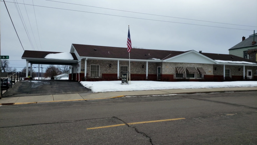 Small town funeral home in winter with snow