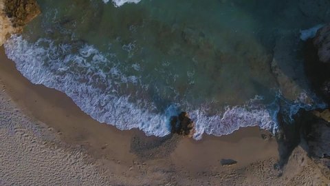 Slomotion aerial drone cliping over a sandy beach and a rock formation in Kavala, Macedonia, Greece