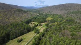 Aerial drone video footage of rural appalachia on a sunny spring day. This is in the catskill mountains, which is a subrange of the appalachians in new york's hudson valley.