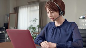 Young asian woman taking web conference. Online meeting. Operator. Call center.
