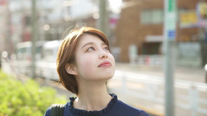 Young asian woman looking up to sky. Royalty-Free Stock Footage #1071944371