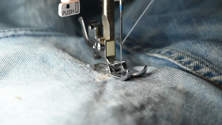 Close up of sewing for repair blue denim jeans with machine. handmade garment industrial concept. process of sewing clothes on sewing machine. Close-up of needle for sewing. Slow Motion | Shutterstock HD Video #1071951055