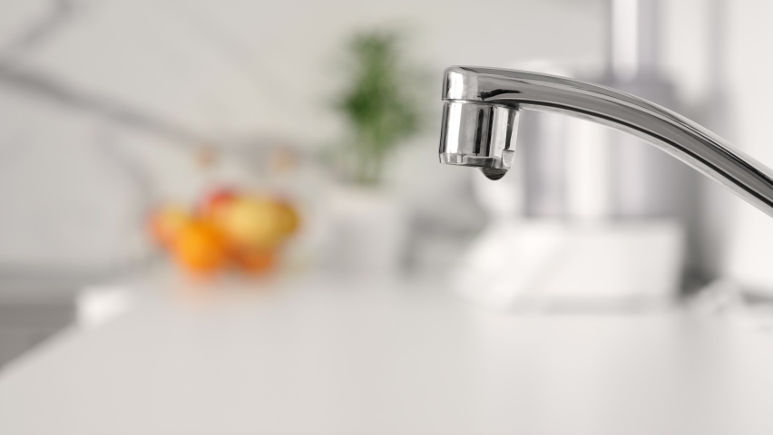 Water dripping from faucet tap at kitchen. Closeup | Shutterstock HD Video #1071966988