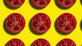 Geometric pattern with tomato slices on a yellow background. Simple motion graphic food concept seamless loop animation