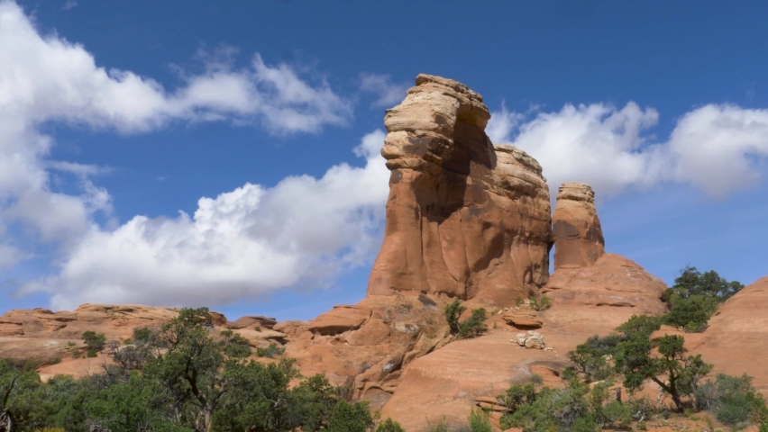 Time lapse of tall rock butte on sunny day.