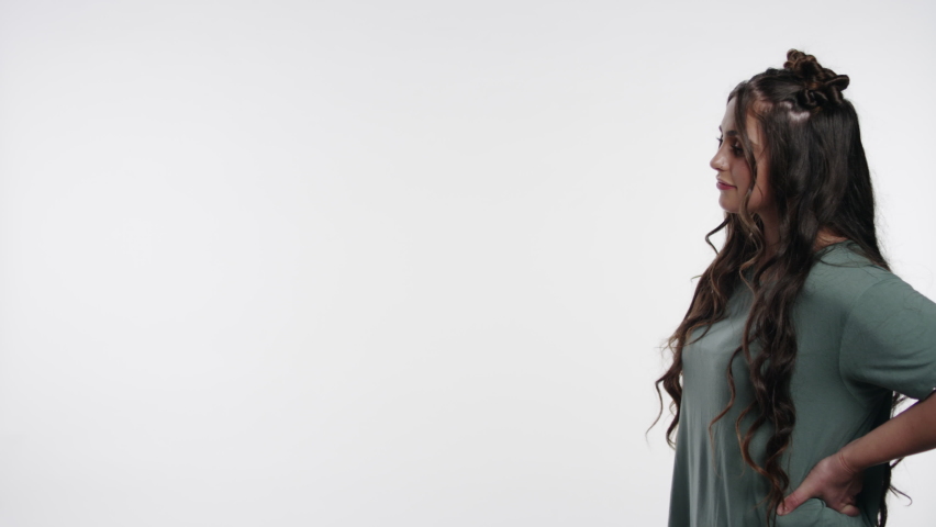 Beautiful young college student interacts with graphic space on white