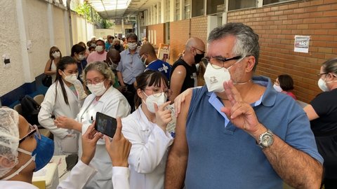 Sao Paulo, SP, Brazil - May 6, 2021: A nurse gives a shot of Pfizer-BioNTech COVID-19 vaccine to a man during a priority vaccination program for people with more than 60 years old.