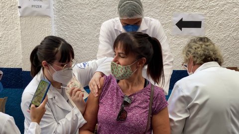 Sao Paulo, SP, Brazil - May 6, 2021: A nurse gives a shot of Pfizer-BioNTech COVID-19 vaccine to a woman during a priority vaccination program for people with more than 60 years old.