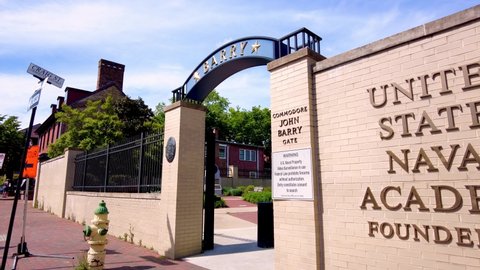 Annapolis, MD, USA 05-02-2021: View of the US Naval Academy in Annapolis. Footage shows the Barry Entrance gate, a metal security door and United States Naval Academy Founded 1845 written on brick wal