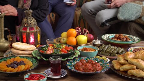 Eid al-Fitr is celebrated at the end of Ramadan at home with family. Eating together. Iftar food after fasting. Festive dinner. Celebratory tradition arabic meals on the table. Feast of the Sacrifice