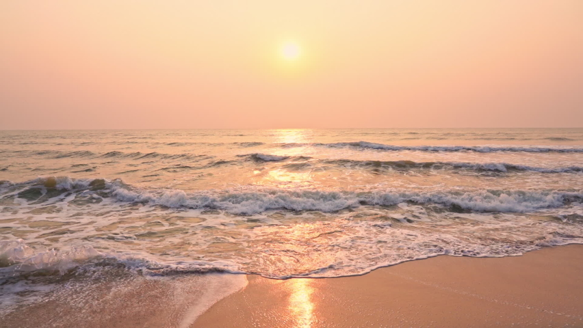 Golden sunset on a beach - slow motion of foamy waves rolling towards white sand beach under low the sun light  | Shutterstock HD Video #1071994204