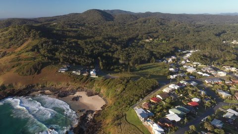 Wide drone shot of Scotts Head mountain landscape, beach and town in Australia