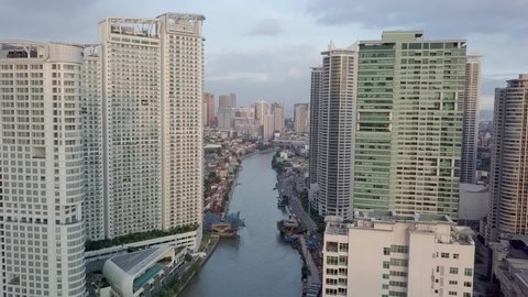 Aerial of the Pasig River and luxury condominiums surrounding both sides of the riverbank. An important waterway in Metro Manila.