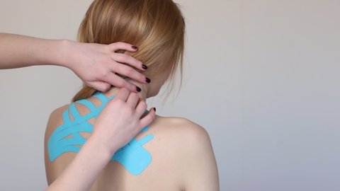 kinesio tapes on the woman's back