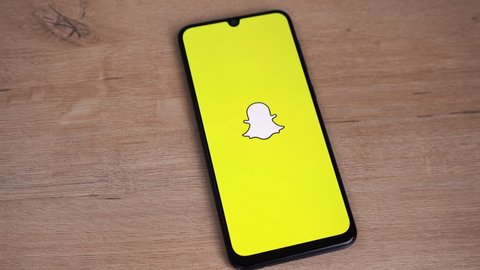 Snapchat logo is displayed on the phone screen. Moscow Russia 05 May 2021