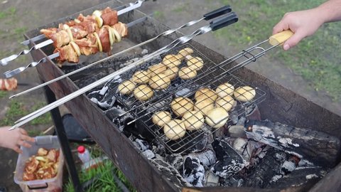 Shish Kebab And Mushrooms Are Cooked On The Grill In Nature