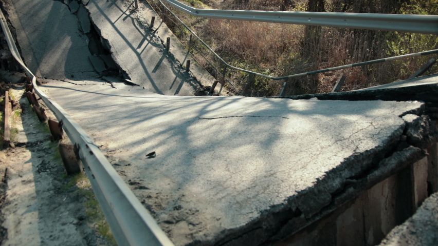 View of the destroyed road bridge as consequences a natural disaster. Large bridge. Destruction of canvas, collapse of the bridge structure.