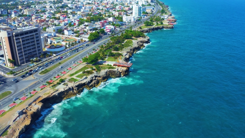 A city by the ocean. Santo Domingo is a city on the edge of the Caribbean Sea. Summer landscape of city streets, houses, and the beautiful Atlantic Ocean.