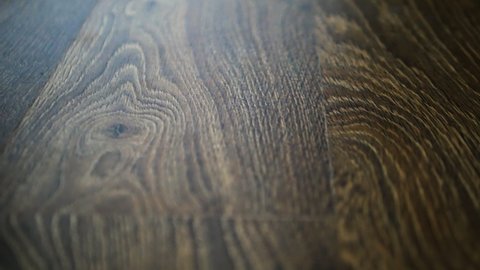 Camera slide on parquet board, laminate close-up, walnut laminate floor