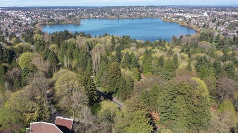 Cinematic aerial drone dolly shot of Green Lake Park, Wallingford, Woodland Park, Meridian, Phinney Ridge near downtown Seattle in King County, Washington