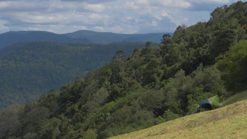 Preparing parachute for paragliding over the mountains of the Lamington National Park, Australia