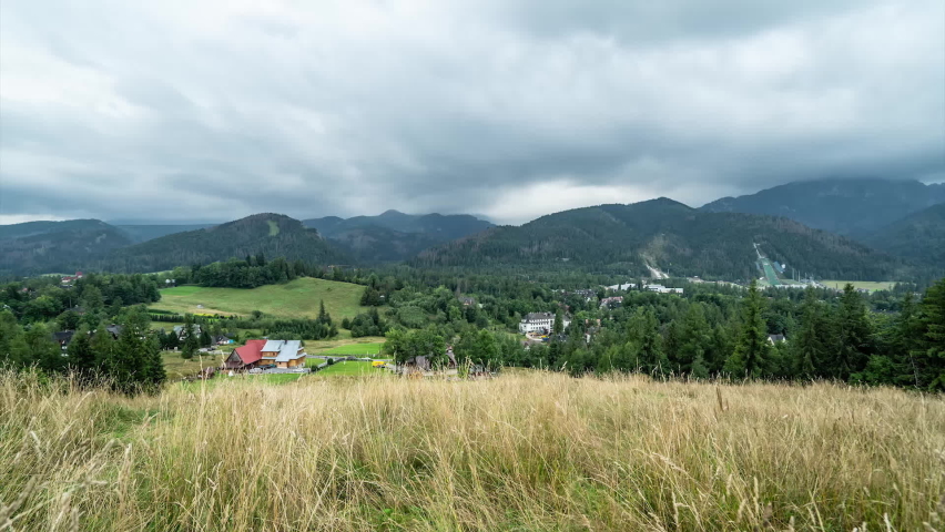 Timelapse of small village of High Tatras in Slovakia, moving clouds and coming rain, cinematic view