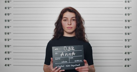 Mugshot Woman Curly Hair Holding Sign Stock Footage Video (100% Royalty ...