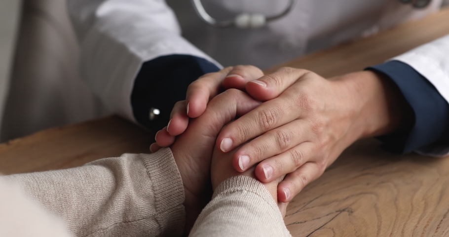 Close up hands of therapist GP and patient, doctor strokes arm of ill woman consoling after news about incurable disease, touch palm express empathy, showing care provide psychological support concept Royalty-Free Stock Footage #1072064371