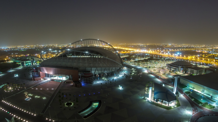 DOHA, QATAR - CIRCA FEB 2019: Aerial view of Aspire Zone from top night to day timelapse in Doha. Traffic on the road. Foggy weather