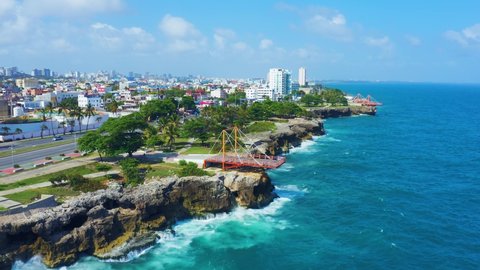 Beautiful cityscape on the shores of the blue Caribbean Sea. A city on the rocky coast of the Atlantic Ocean. City and sea 4k background. Santo Domingo Dominican Republic.