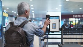health passport tourist showing covid-19 certification at the airport security control,man scanning coronavirus travel vaccination certificate at the departure area,vaccine green card pass - Powered by Shutterstock - Get 15% off with code: PIKWIZARD15