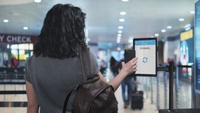 vaccine passport tourist shows covid-19 certification at the airport check in zone,woman scanning coronavirus travel vaccination certificate at the departure area,green card pass - Powered by Shutterstock - Get 15% off with code: PIKWIZARD15