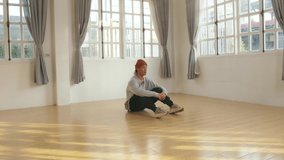 Asian Male Dancer Sitting On Floor And Rest, Video In 4K 50Fps

