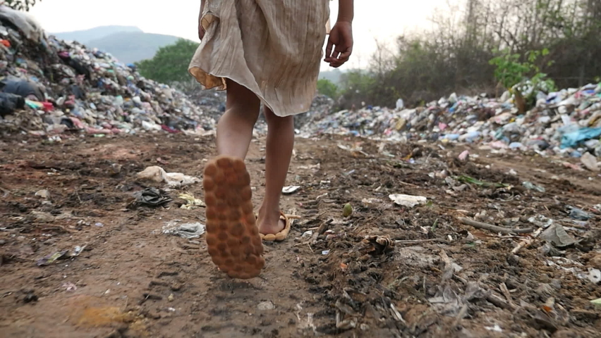 Poor Feet Kid Walking, Garbage At Background
 Royalty-Free Stock Footage #1072079602